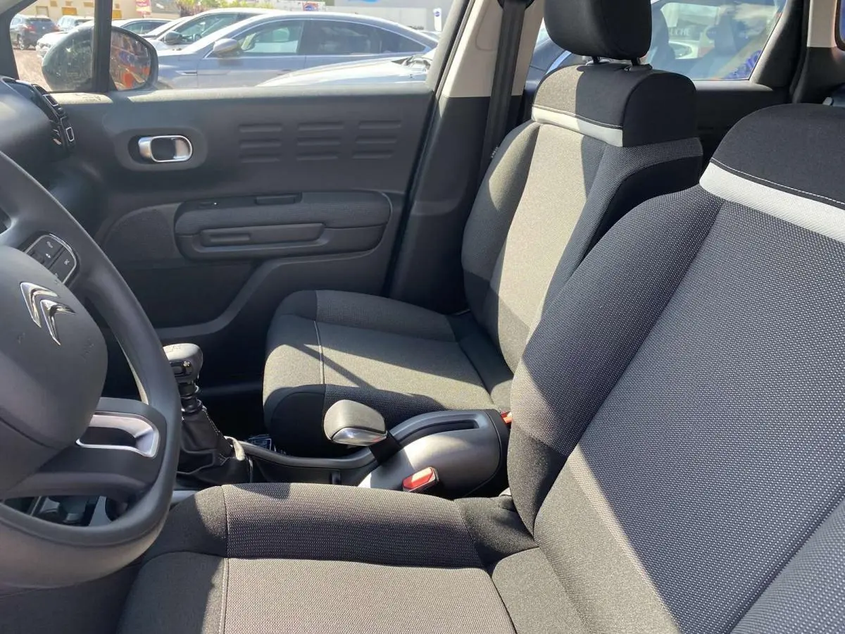 Vue intérieure côté conducteur du Citroën C3 Aircross noir 2021, montrant les sièges et la boîte manuelle.