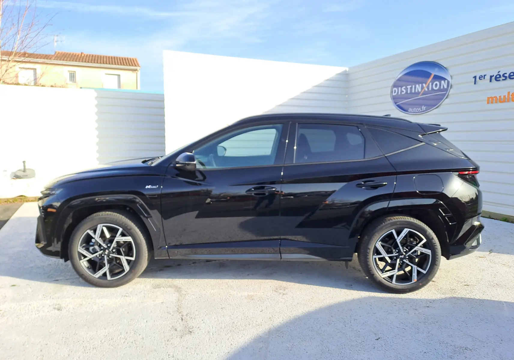 Vue de profil côté gauche du Hyundai Tucson 2025 noir Abyss, soulignant ses jantes alliage et lignes modernes.