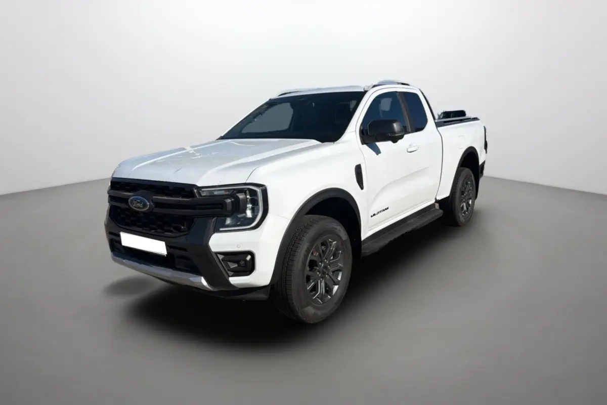 Vue 3/4 avant d’un Ford Ranger Wildtrak blanc pur avec arceau sport et barres de toit, sur fond neutre.