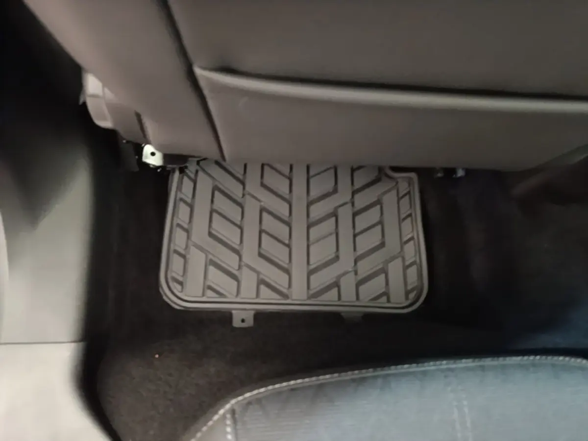 Vue intérieure du plancher arrière d'une Opel Corsa 2022, tapis caoutchouc noir sous les sièges gris.