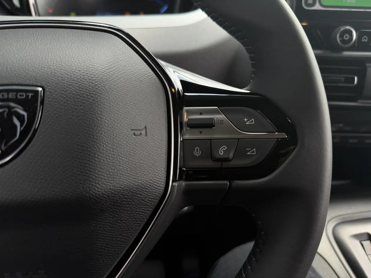 Gros plan sur le volant cuir multifonction du Peugeot Rifter 2026 avec commandes vocales et appels intégrés.