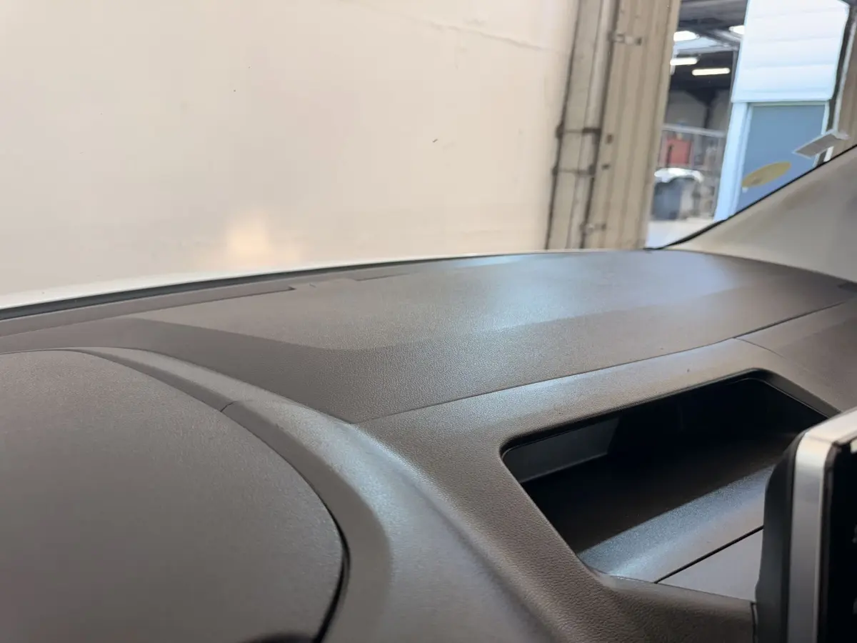 Tableau de bord noir du Citroën Berlingo 2019, vue intérieure côté passager avec rangement ouvert.