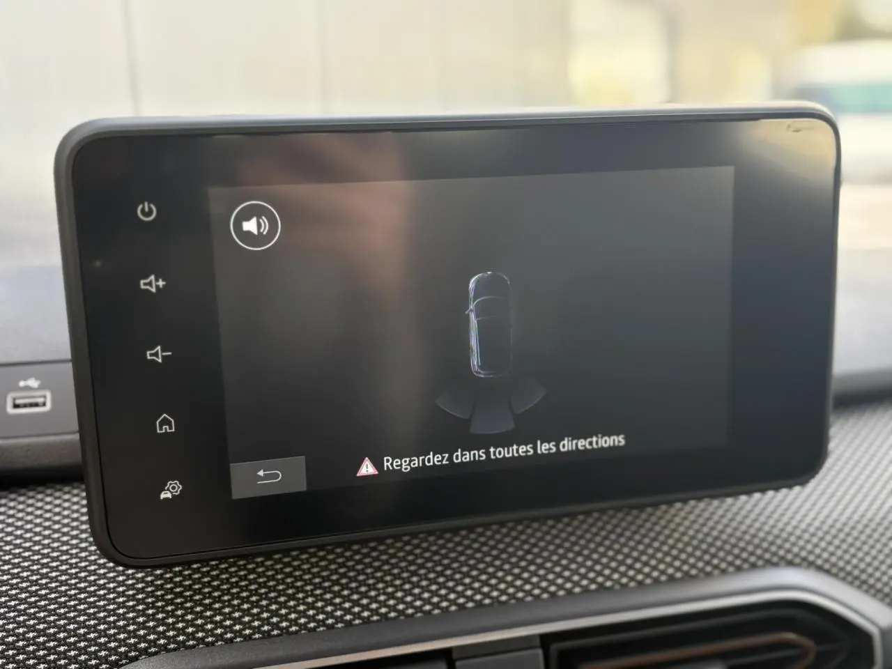 Écran tactile du système multimédia Dacia Sandero Stepway 2025 affichant l'aide au stationnement arrière.
