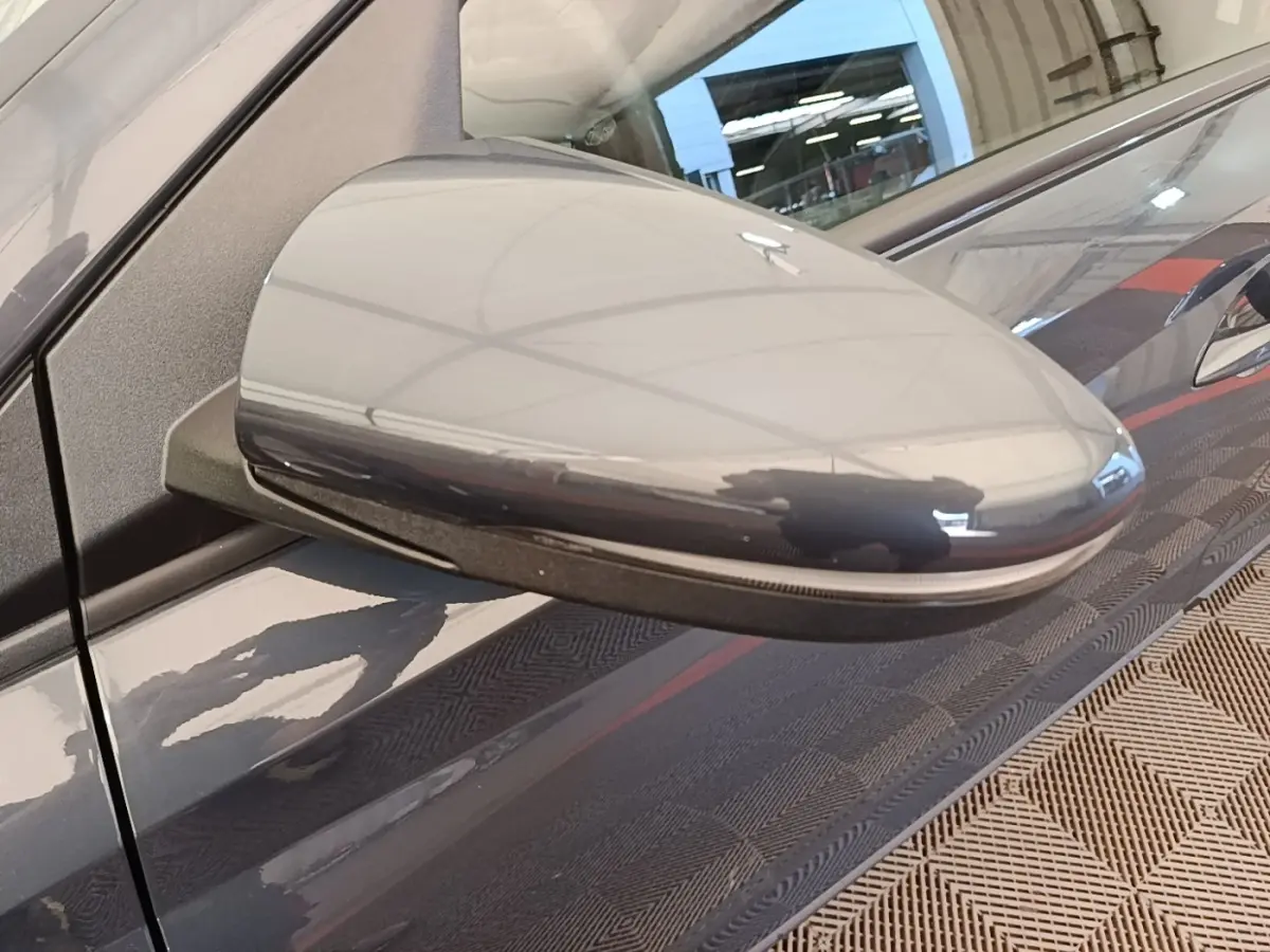 Rétroviseur côté gauche gris foncé de la Hyundai Bayon 2023 avec clignotant intégré, vue rapprochée.