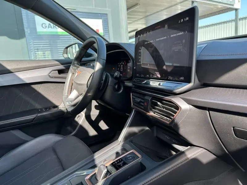 Vue intérieure côté conducteur du CUPRA Formentor 2025 noir Minuit, avec écran tactile central et volant multifonction.