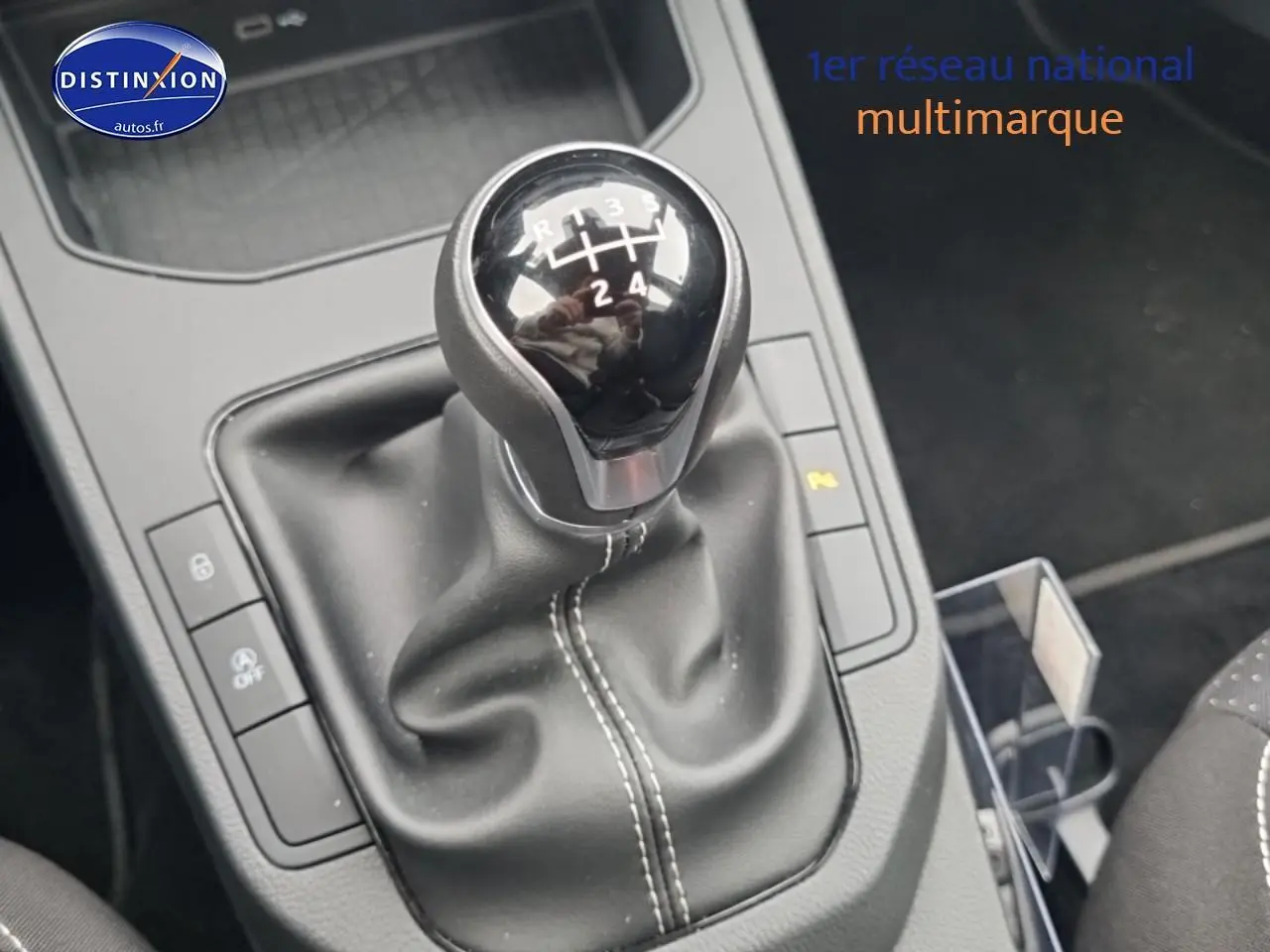 Gros plan sur le levier de vitesses manuel noir de la SEAT Ibiza 2025, avec coutures blanches visibles sur la garniture.