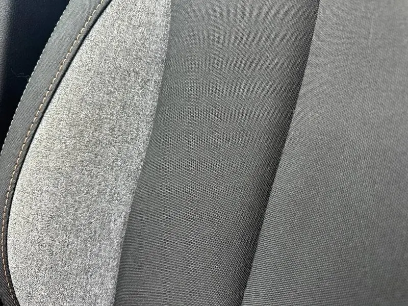 Gros plan sur le tissu noir et gris recyclé du siège avant du Skoda Scala 2025, avec surpiqûres contrastantes.