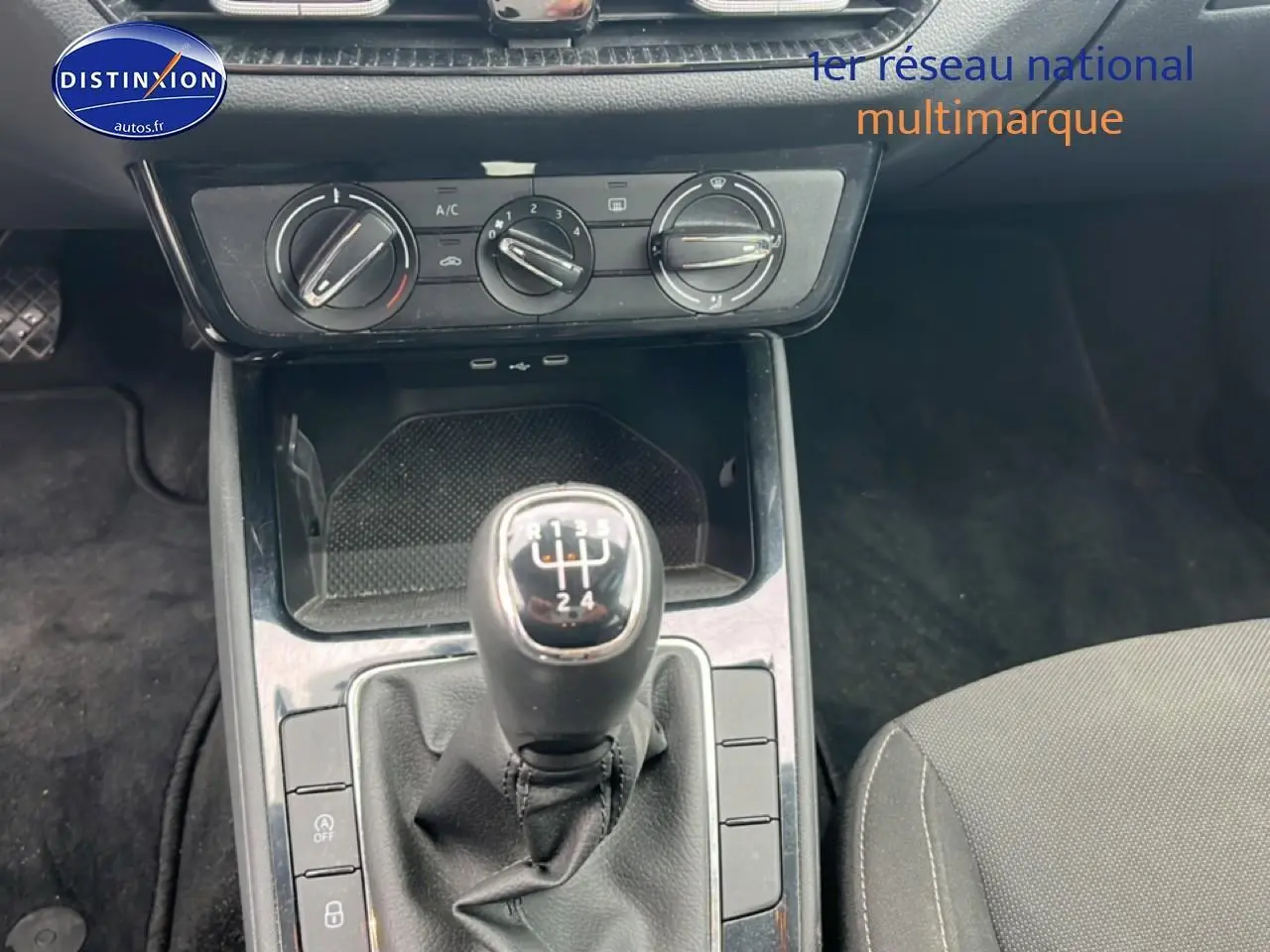 Gros plan sur la console centrale noire d’une Skoda Fabia 2025 avec levier de vitesses manuel et commandes de climatisation.