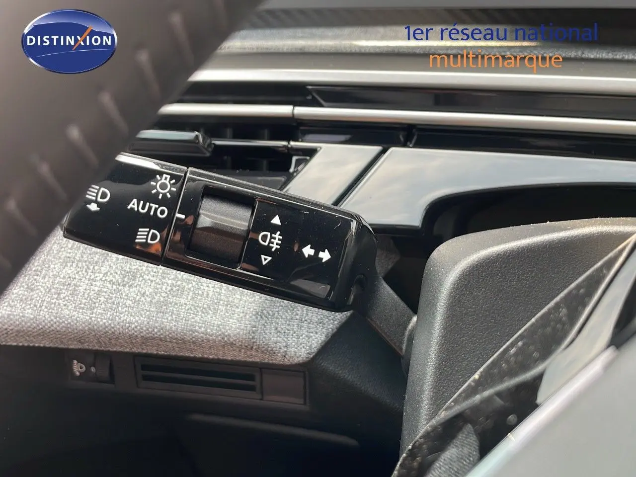 Gros plan sur la commande des feux et clignotants dans l'habitacle du Peugeot 3008 Hybrid gris Artense 2025.