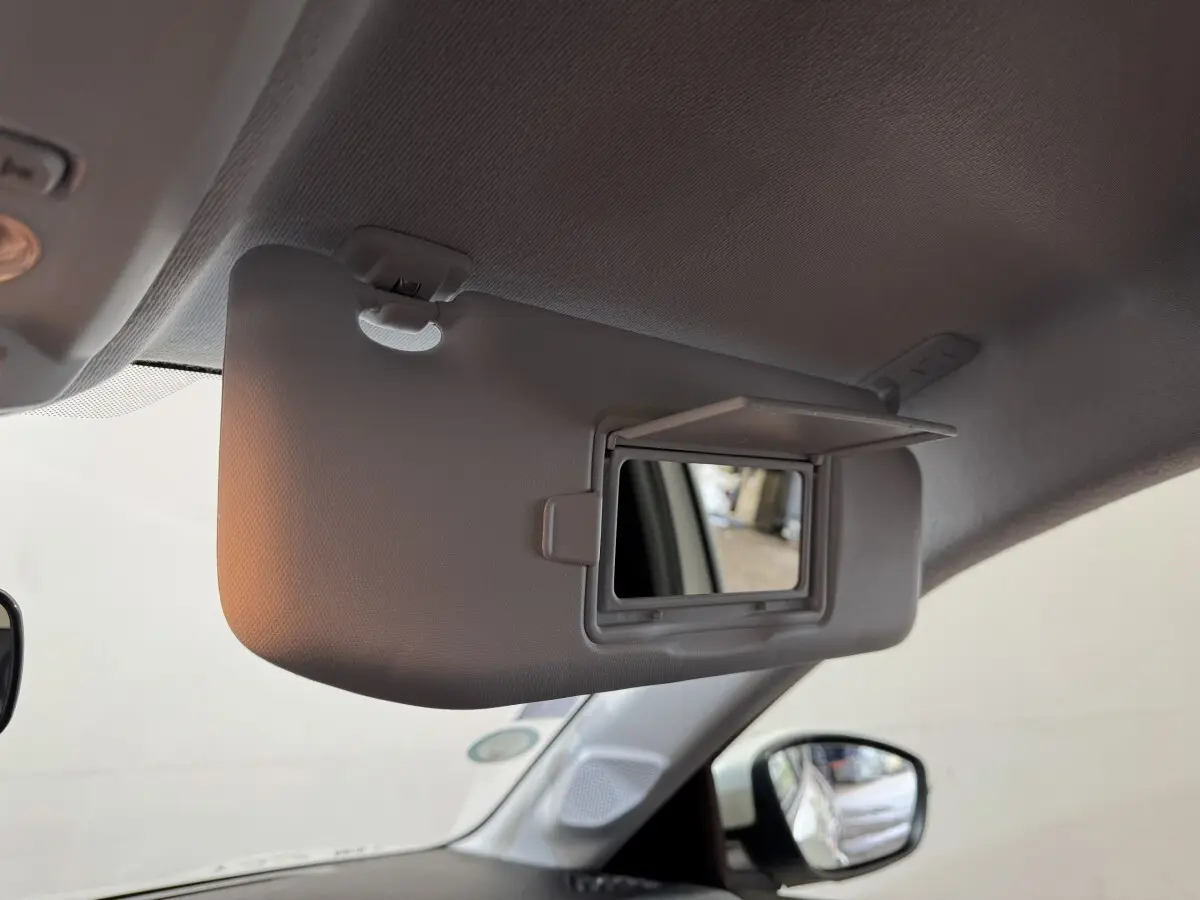 Détail intérieur du pare-soleil côté conducteur avec miroir éclairé dans une Peugeot 208 électrique Active Business.