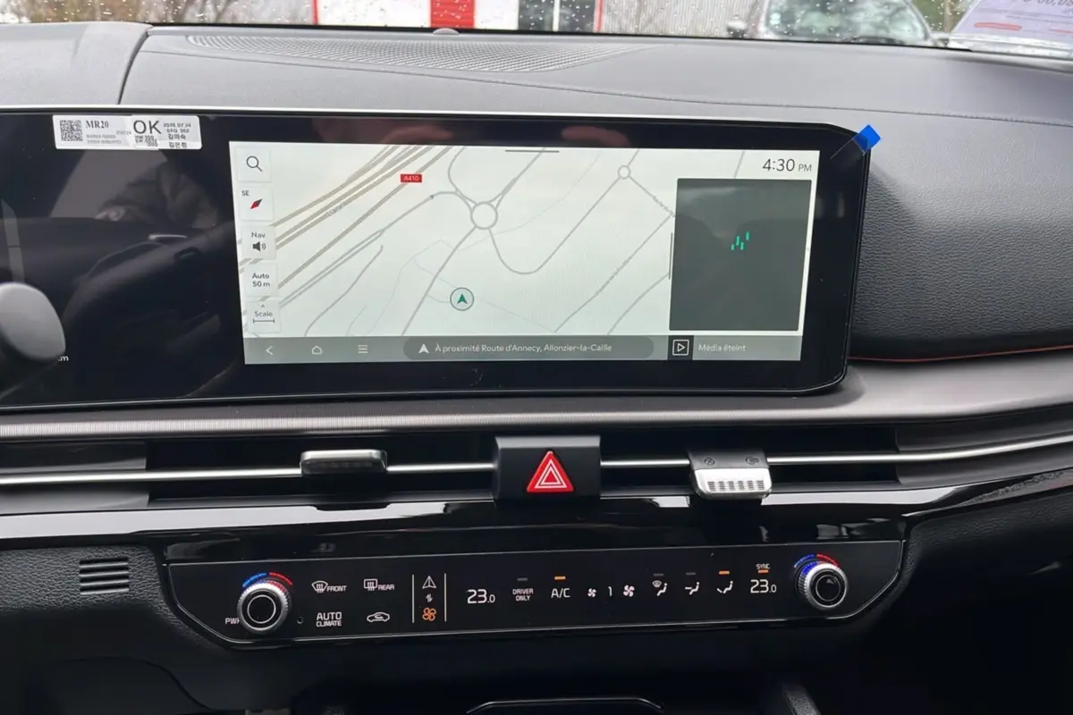 Tableau de bord intérieur du Kia Sportage 2026 avec écran GPS large et commandes climatisation digitales.