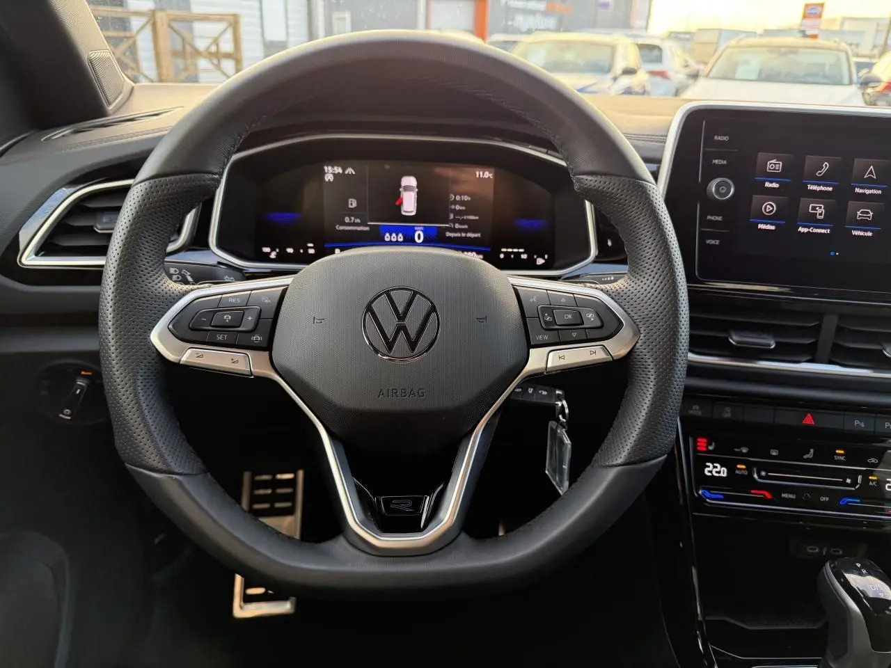 Vue rapprochée du volant cuir noir R-Line et du tableau de bord digital du Volkswagen T-Roc 2025.