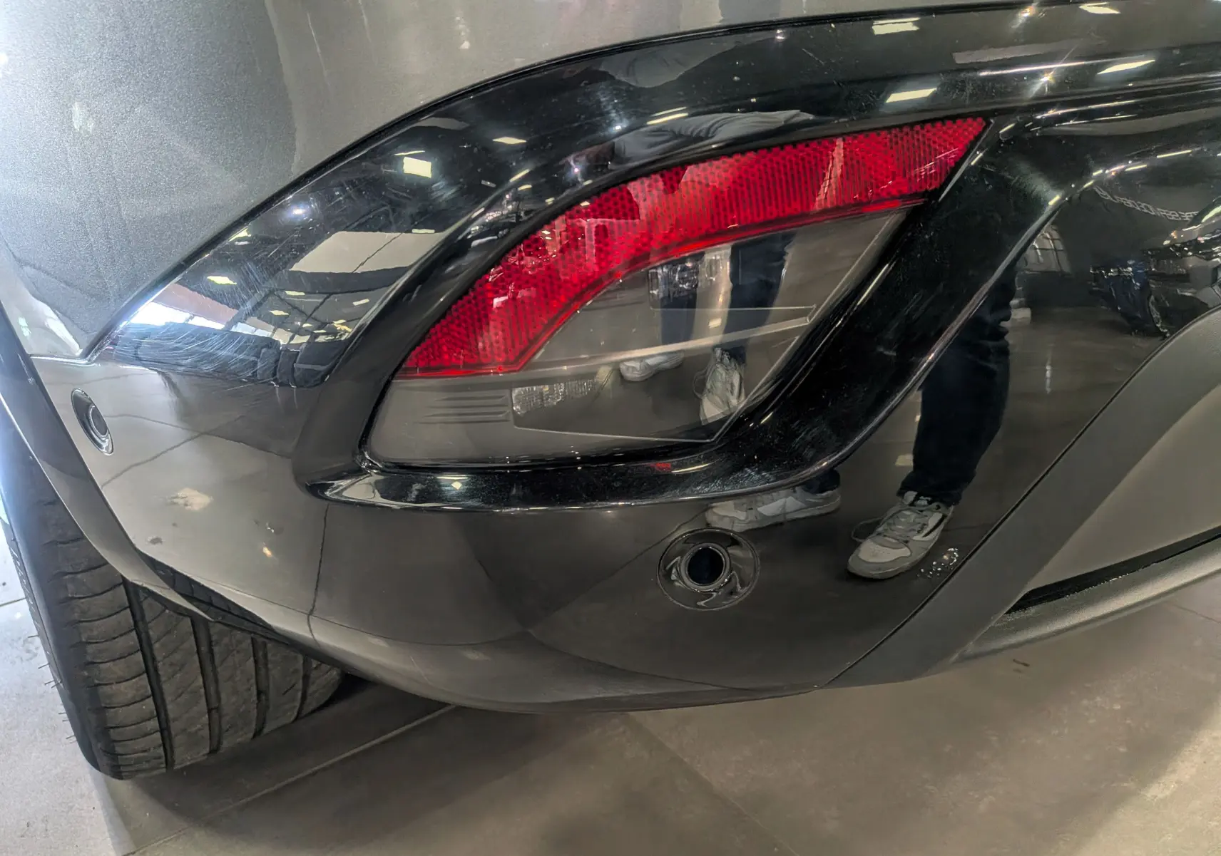 Gros plan sur le feu arrière droit du Renault Austral E-Tech gris schiste avec toit noir, soulignant le pare-chocs arrière.