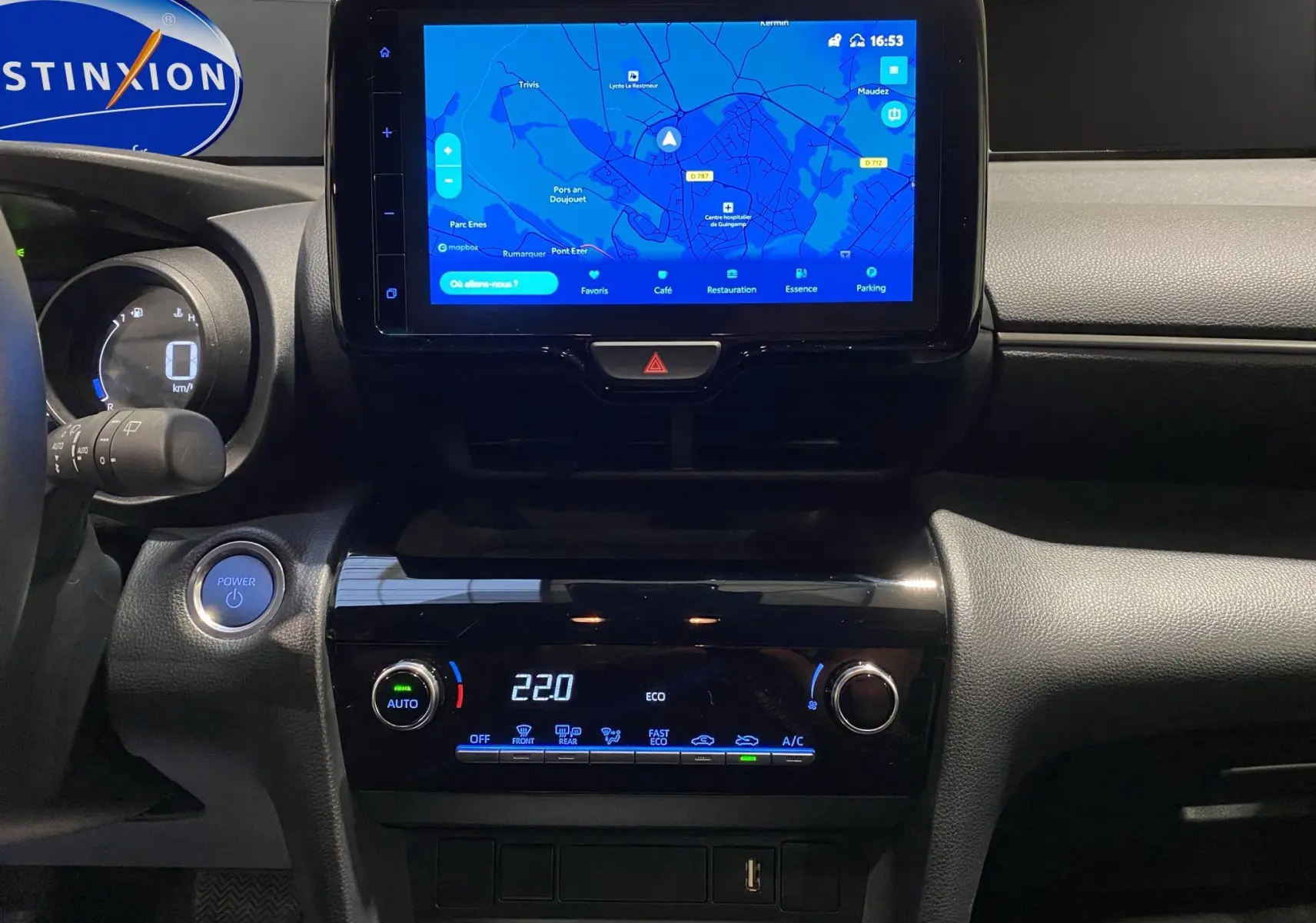 Vue rapprochée du tableau de bord noir de la Toyota Yaris Cross 116H avec écran tactile affichant la navigation.