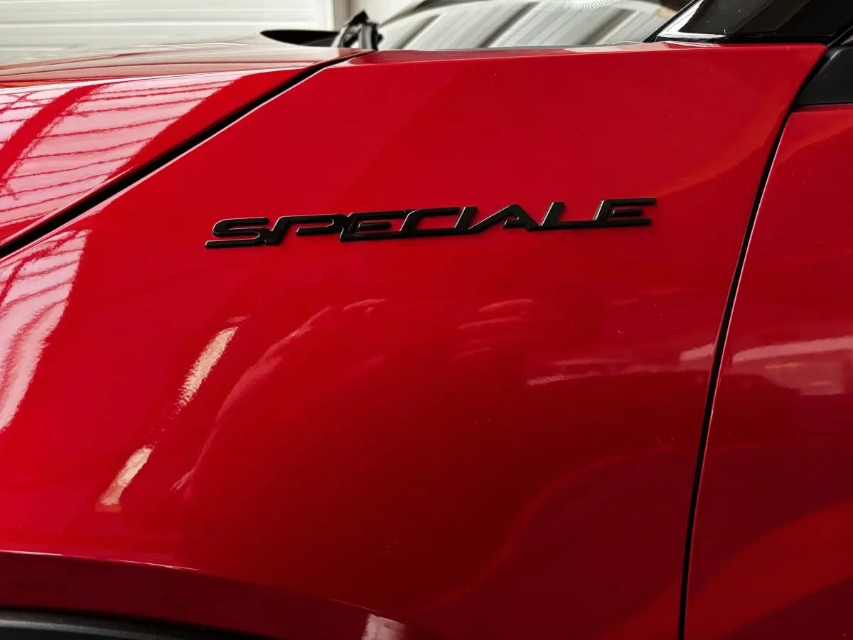 Gros plan sur l’inscription noire "Speciale" sur l’aile avant droite rouge vif de l’Alfa Romeo Junior 2024.