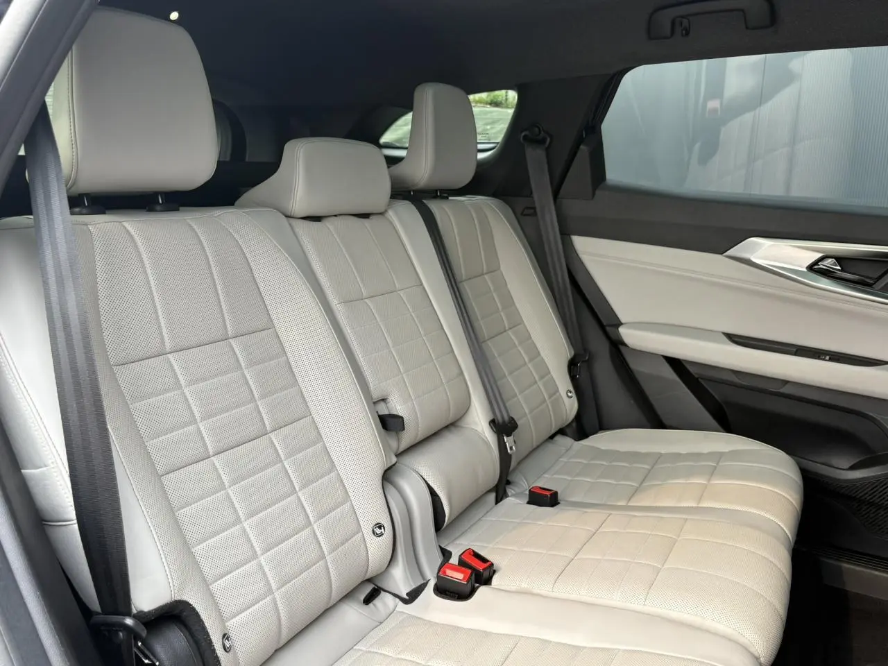 Vue latérale des sièges arrière en cuir gris sable clair perforé du Renault Espace VI 6 E-Tech Full Hybrid 2023.