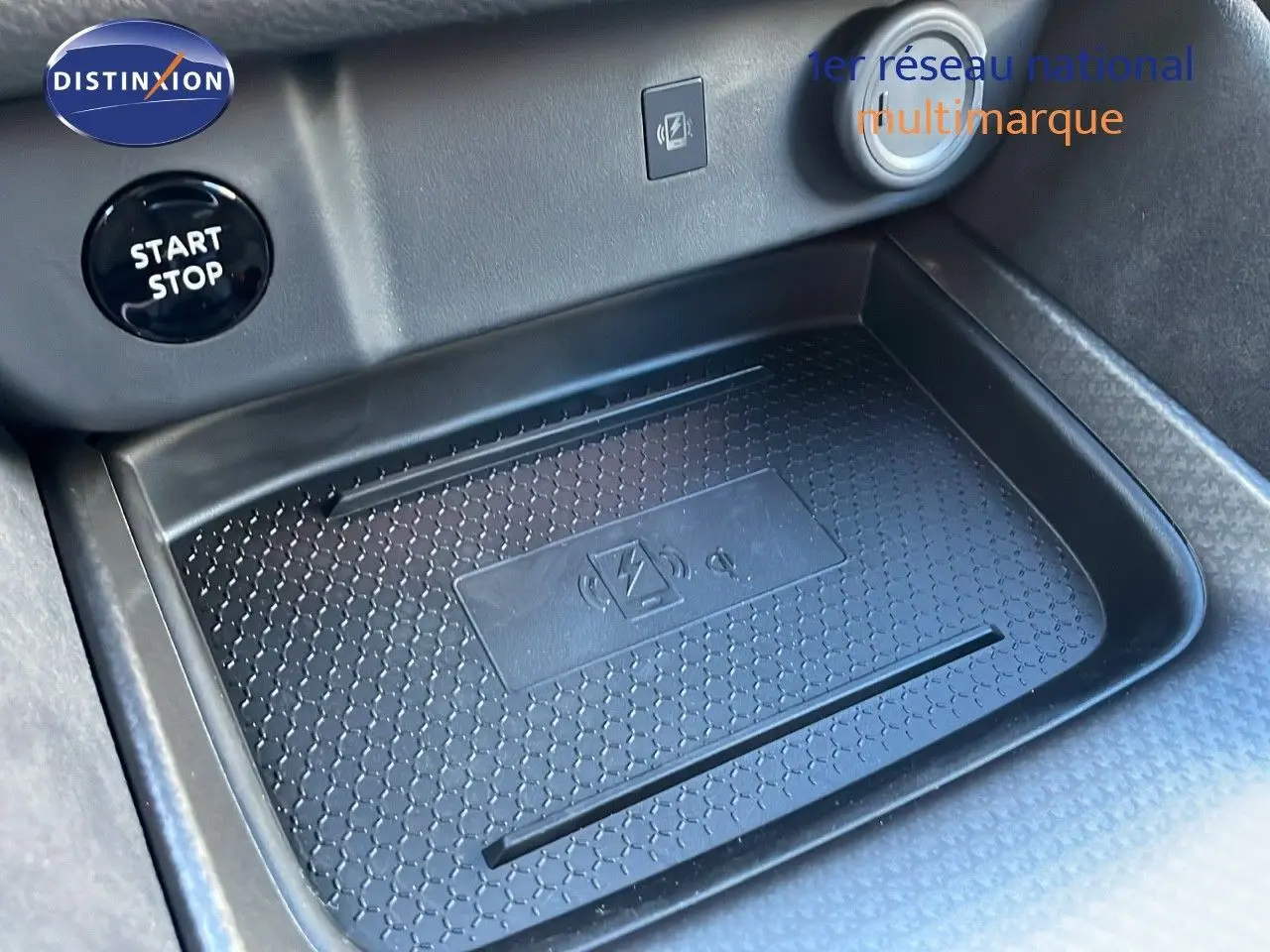 Gros plan sur le compartiment de recharge sans fil et bouton Start Stop dans l'habitacle du Nissan Qashqai blanc nacré.