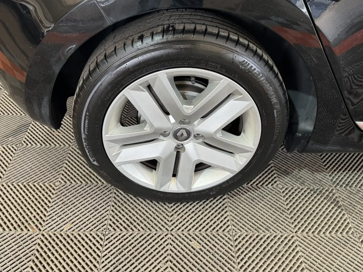 Gros plan sur la roue avant droite de la Renault Clio Business E-Tech hybride noire, avec jante argentée et pneu Hankook.