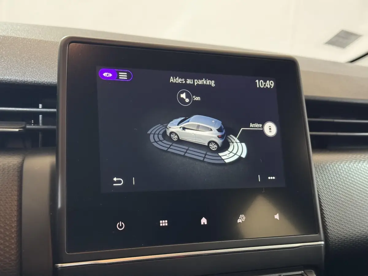 Écran tactile central affichant l'aide au stationnement avec vue 3D d'une Renault Clio Business E-Tech hybride noire.