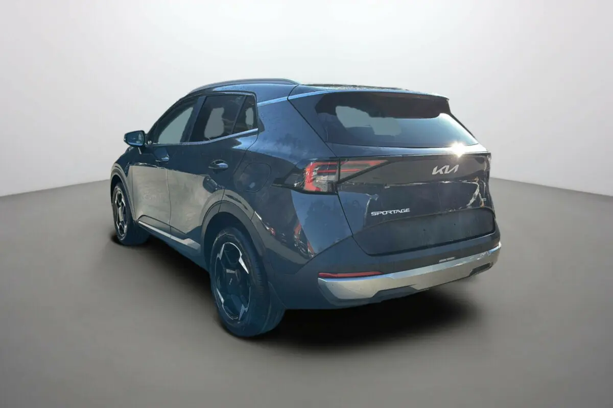 Vue 3/4 arrière droite du KIA Sportage gris eclipse 2026 avec feux arrière LED et jantes alu 18 pouces.