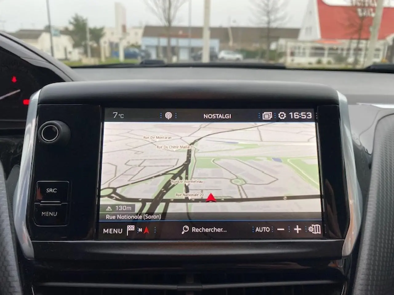 Écran tactile 7 pouces du système de navigation 3D connecté dans un Peugeot 2008 blanc, vue intérieure frontale.