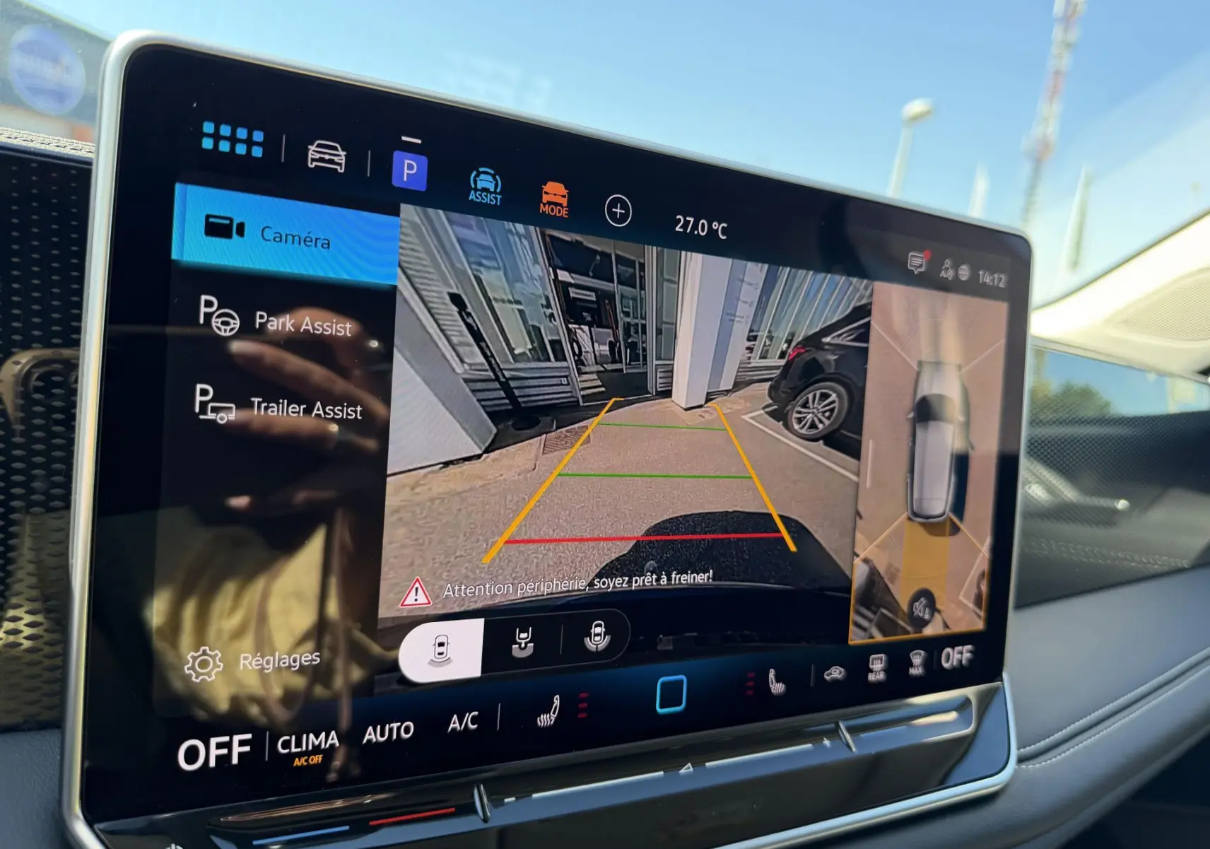 Écran tactile intérieur du Volkswagen Tiguan 2025 montrant l'assistant de stationnement avec vue caméra arrière et angles morts.