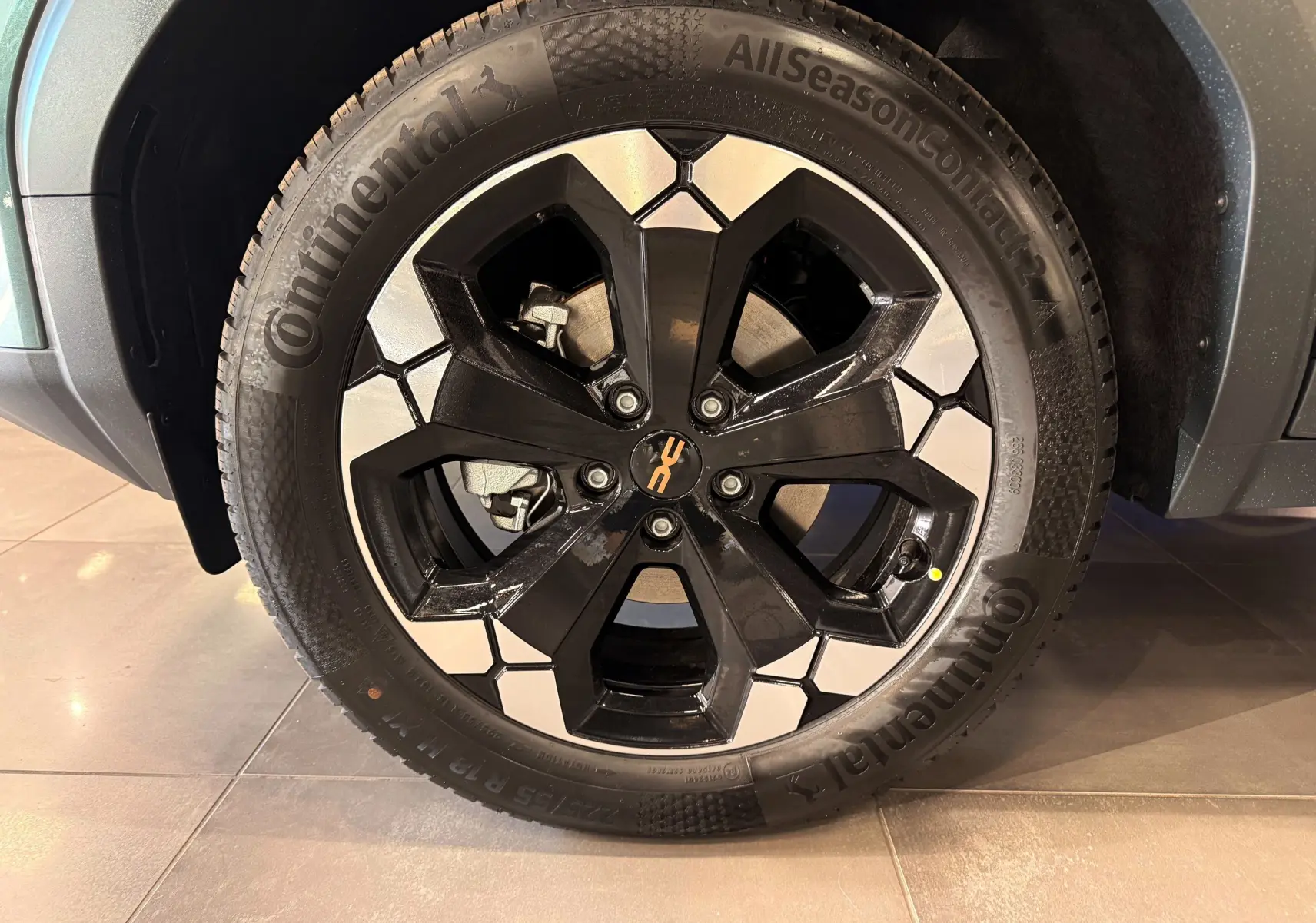 Gros plan sur la jante bi-ton noire et argent d’un Dacia Bigster Hybrid-G 150 4x4 Vert Cèdre, roue avant droite.