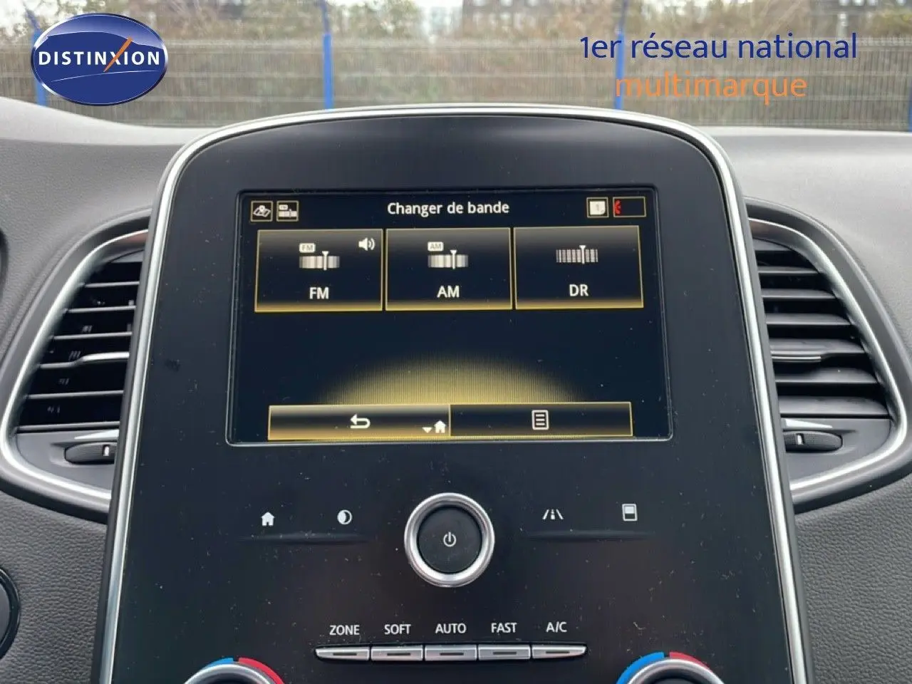 Vue rapprochée de l’écran tactile central du Renault Grand Scenic 2022 noir étoile métal affichant les options radio FM, AM et DR.