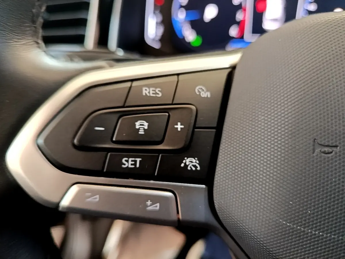 Gros plan sur les commandes multifonctions du volant cuir alu du Volkswagen Taigo noir 2023, version R-Line.