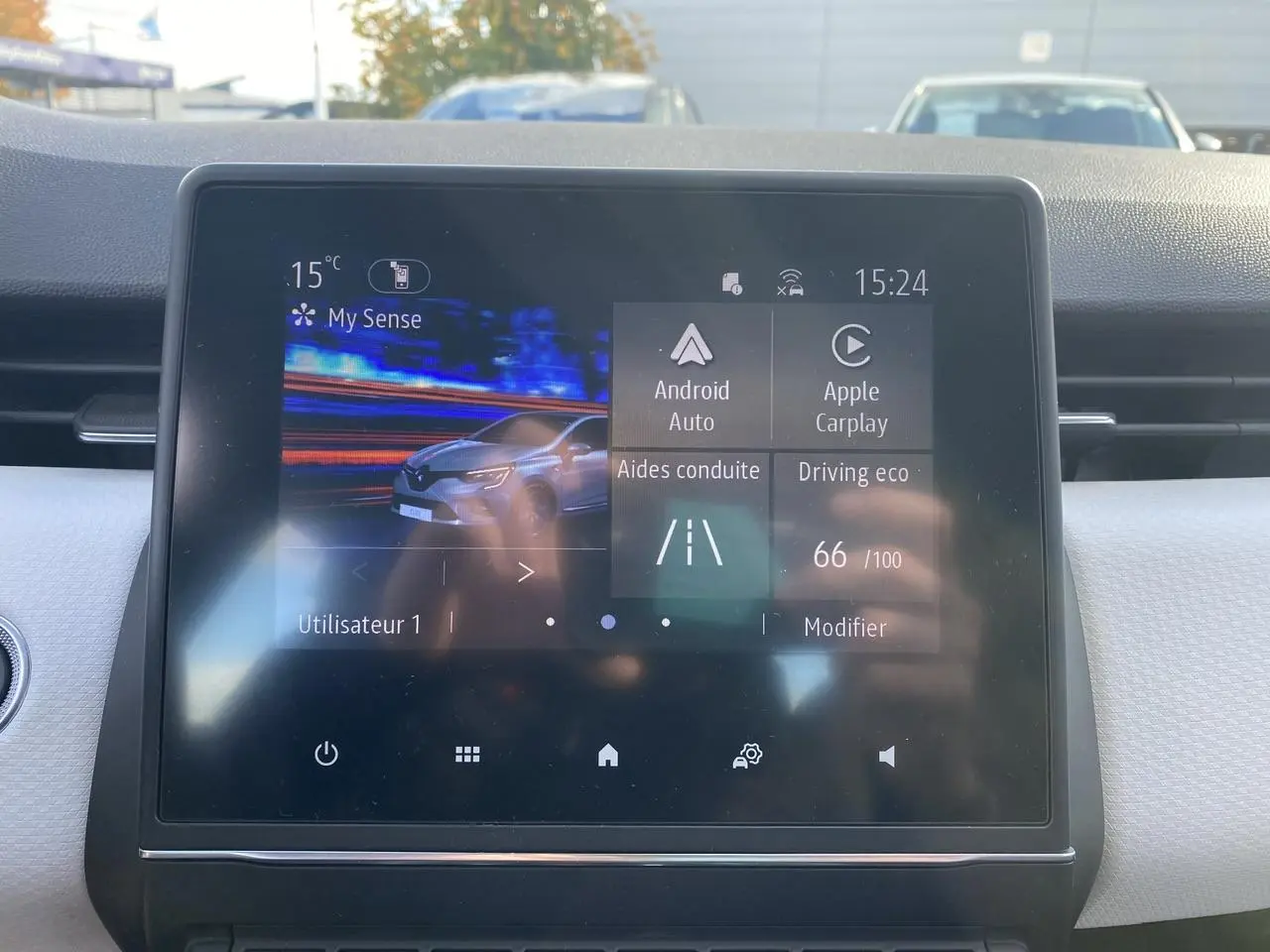 Écran tactile central de la Renault Clio blanche 2021 affichant les aides à la conduite et options multimédia.