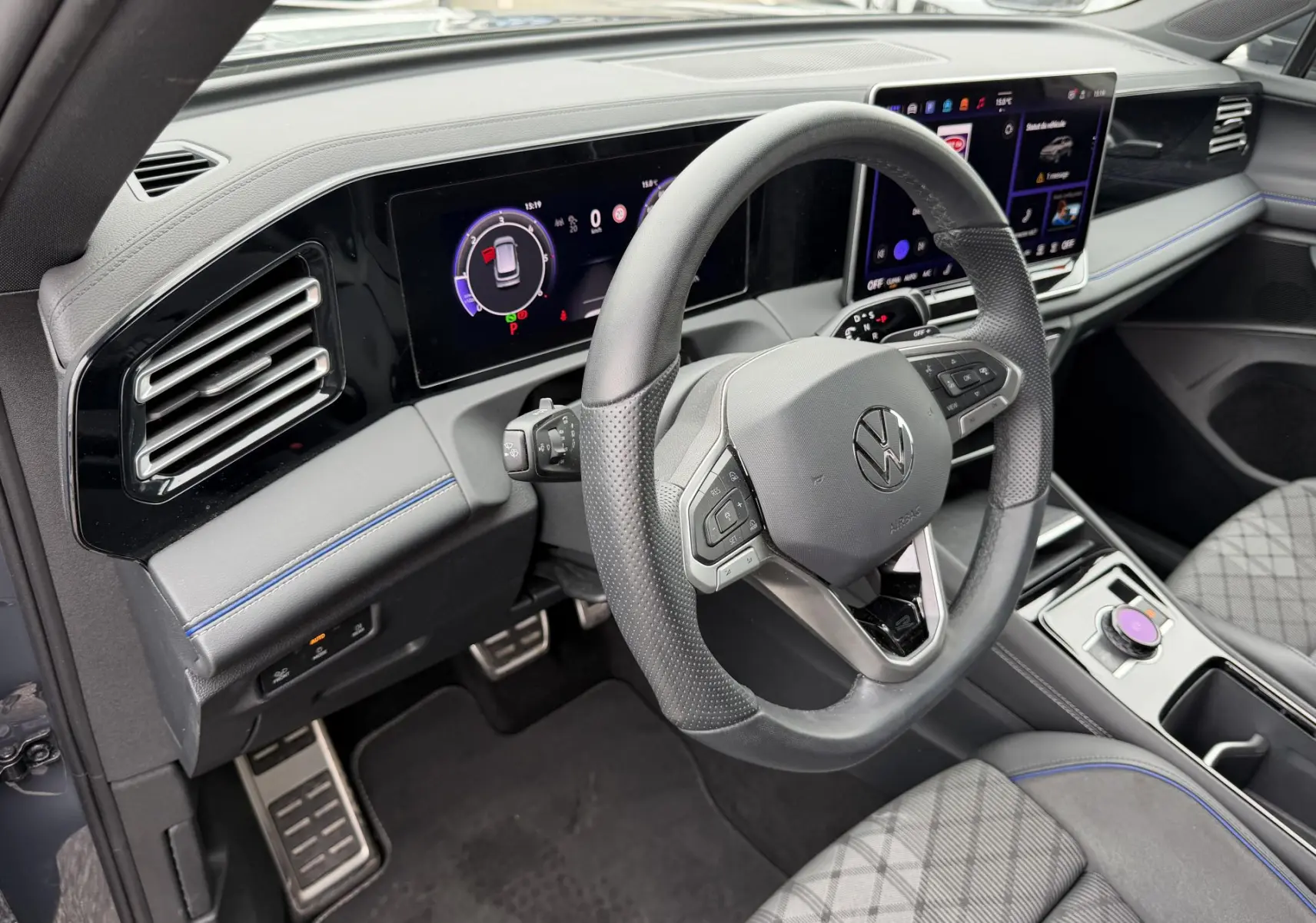 Intérieur du Volkswagen Tiguan 2025 vue côté conducteur, volant cuir sport et tableau de bord digital polychrome.
