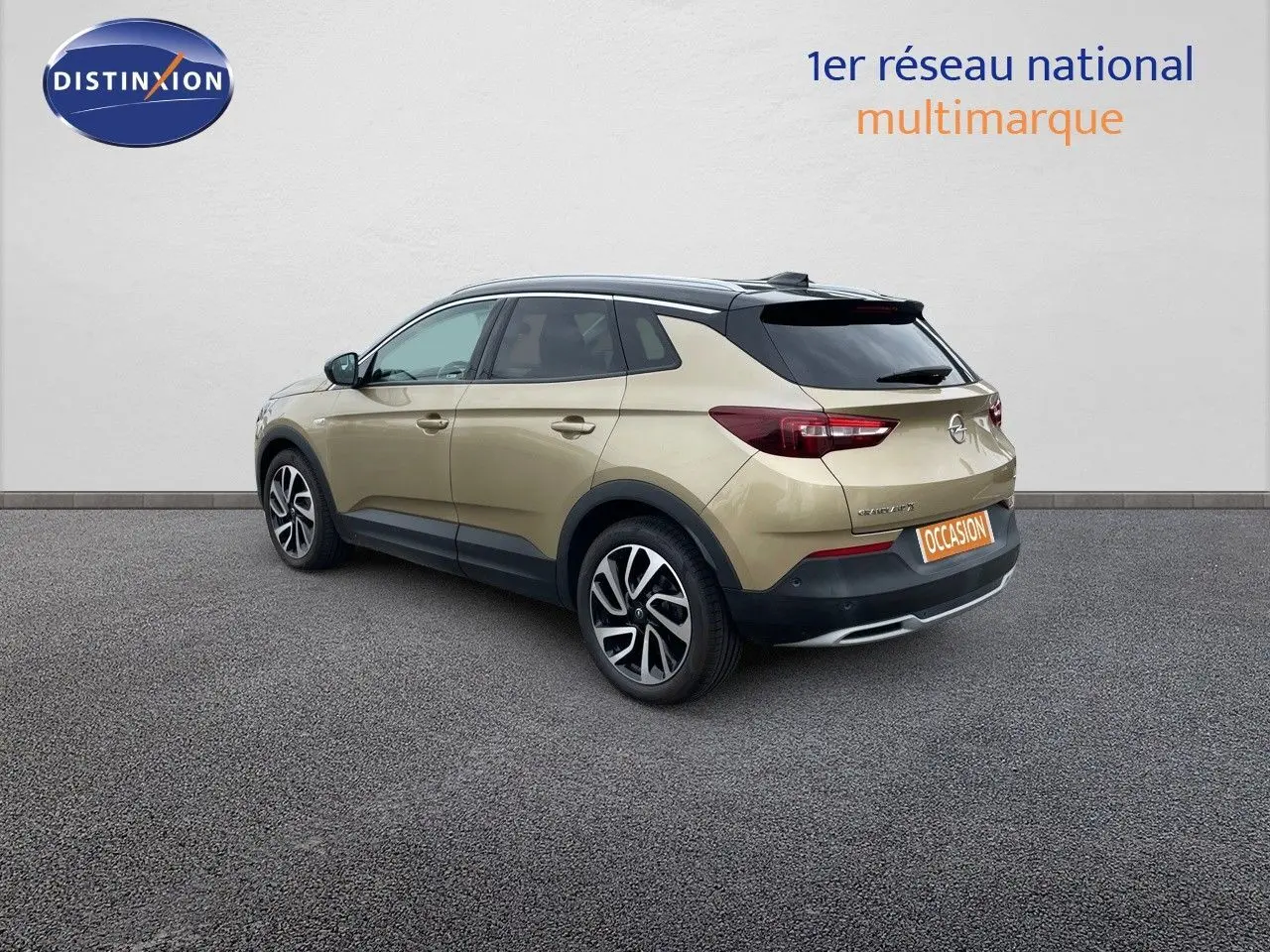 Opel Grandland X diesel doré vue 3/4 arrière droit avec toit noir et jantes bi-ton sur fond neutre.
