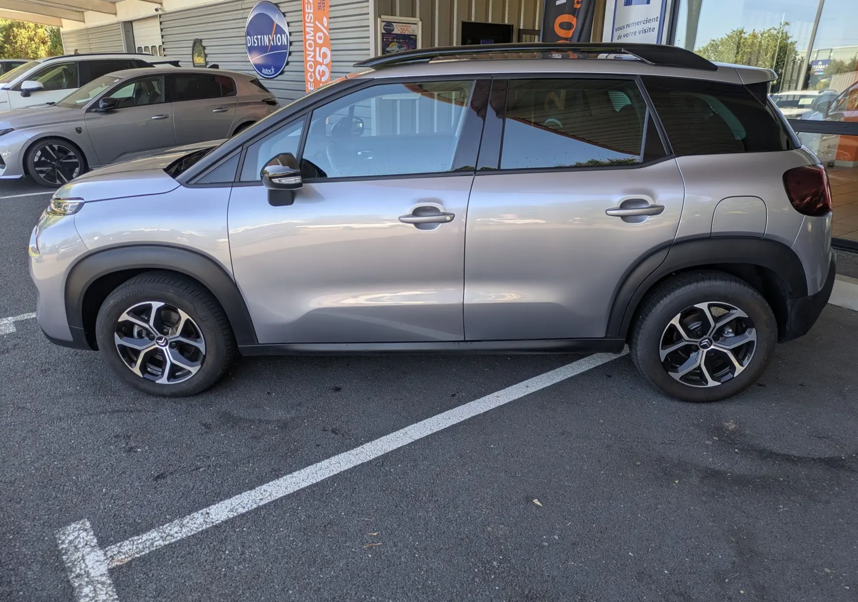 Citroën C3 Aircross gris Artense vue 3/4 avant droit, avec jantes alliage 16 pouces et toit noir.