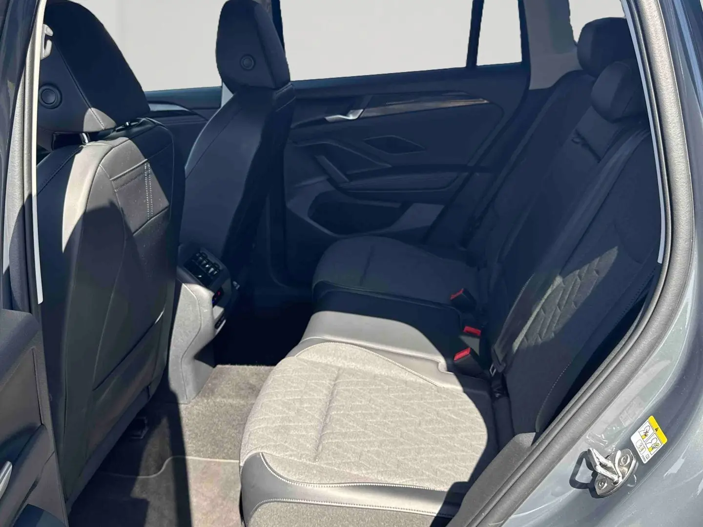 Vue intérieure côté droit des sièges arrière gris clair et foncé du Volkswagen Tiguan 1.5 eHybrid 2025.