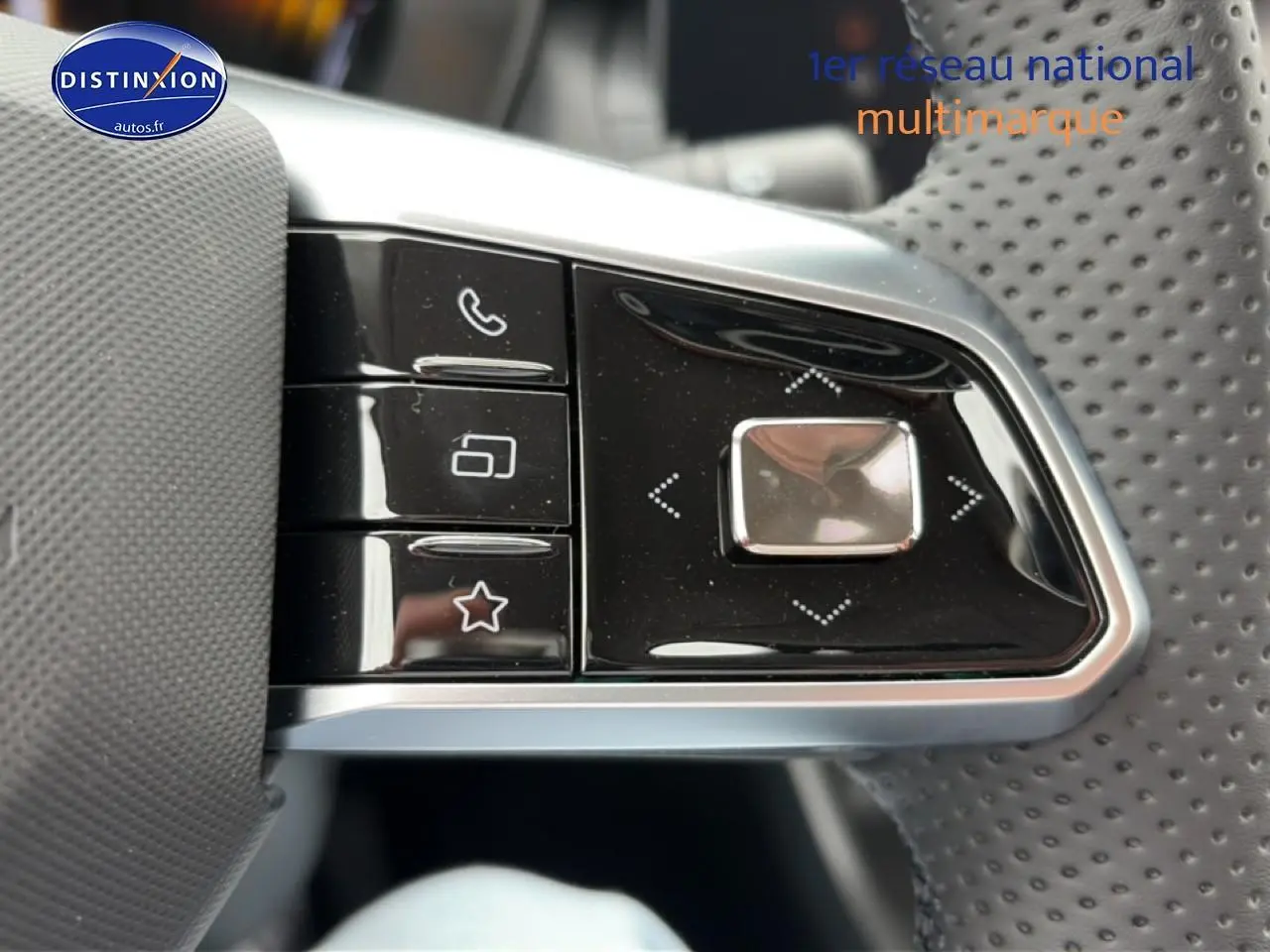 Gros plan sur les commandes noires et argentées au volant perforé du MG ZS Hybrid gris 2026.