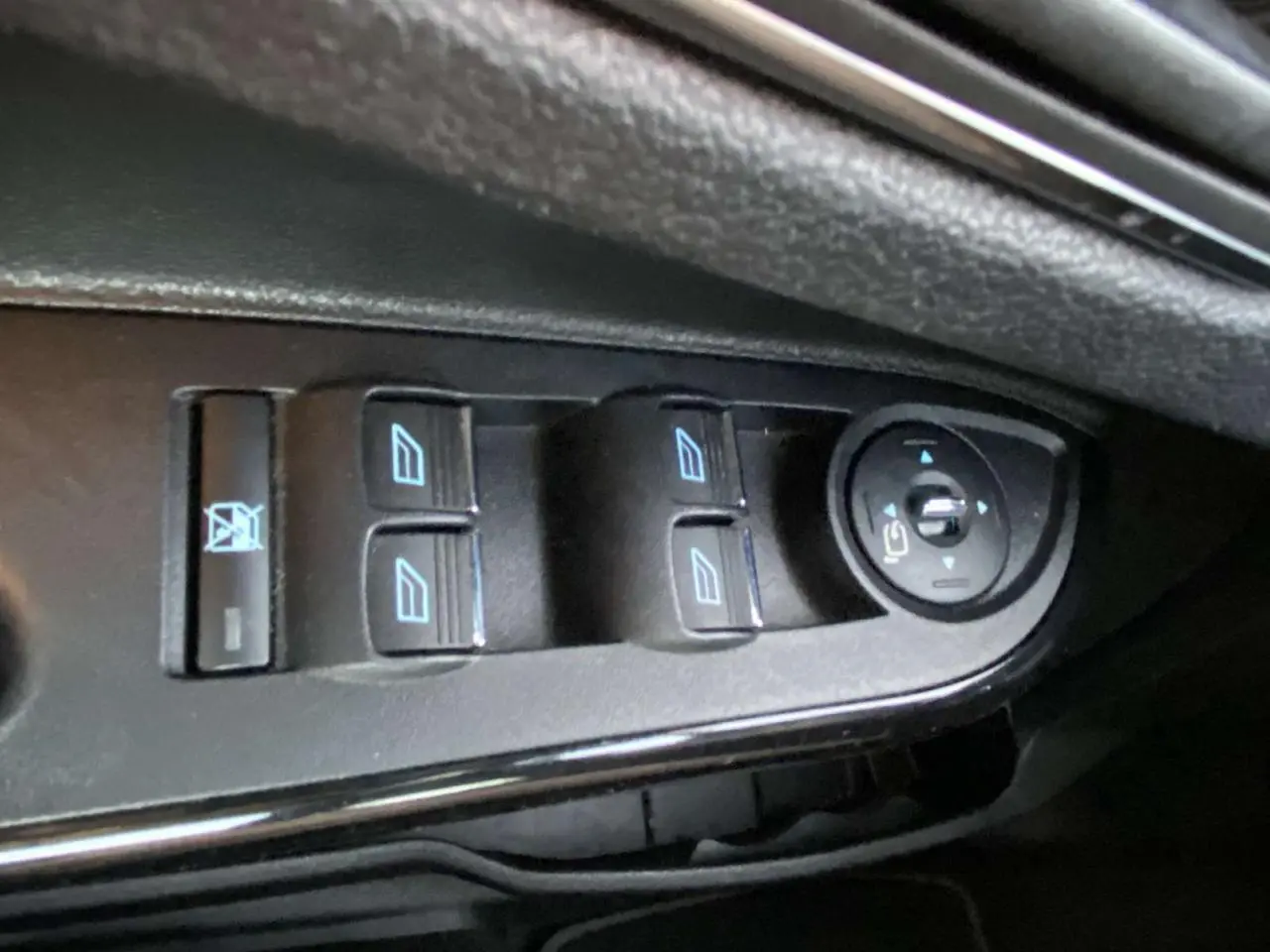 Gros plan sur les commandes des vitres et des rétroviseurs côté conducteur d'une Ford B-MAX blanche 2014.