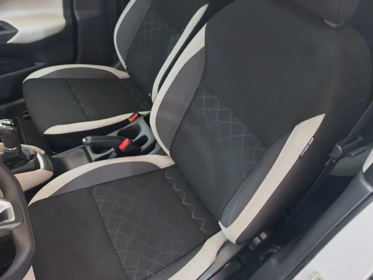 Vue intérieure rapprochée des sièges avant noirs et gris de la Nissan Micra IG-T 90 Business Edition 2018.