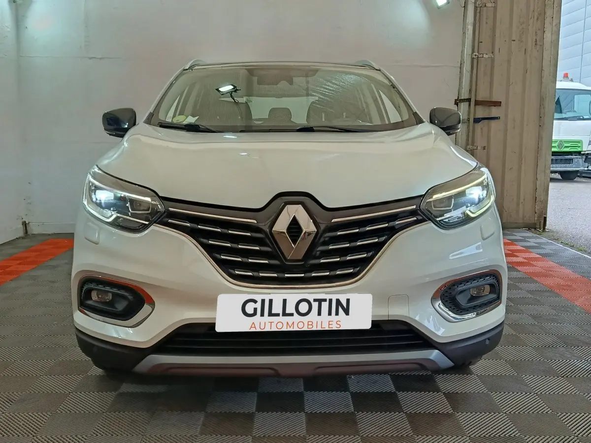 Vue frontale du Renault Kadjar blanc 2020 avec phares LED allumés et calandre noire distinctive.