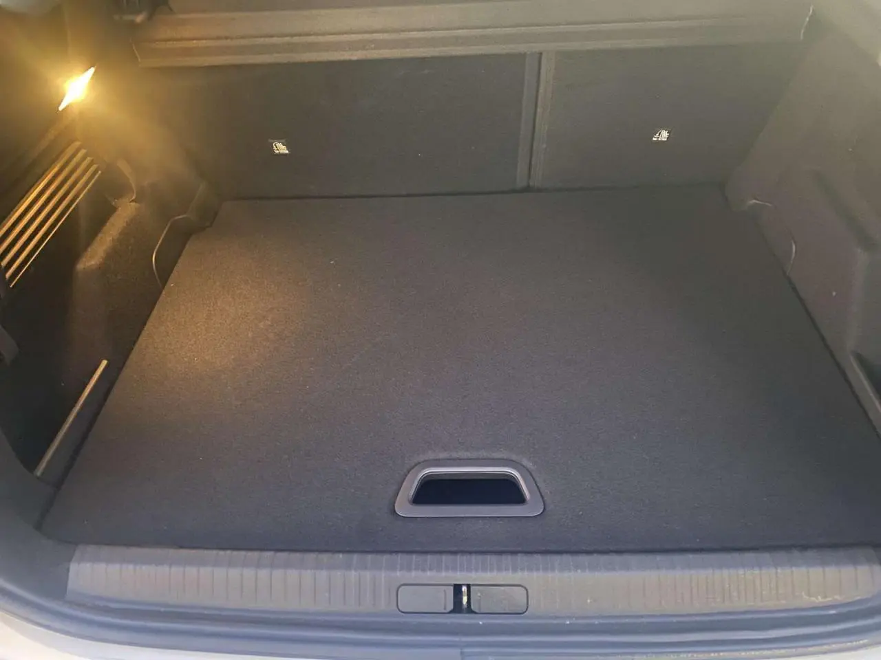 Coffre spacieux et propre de la Citroën C4 blanche 2021, vue intérieure depuis l'arrière avec plancher plat.