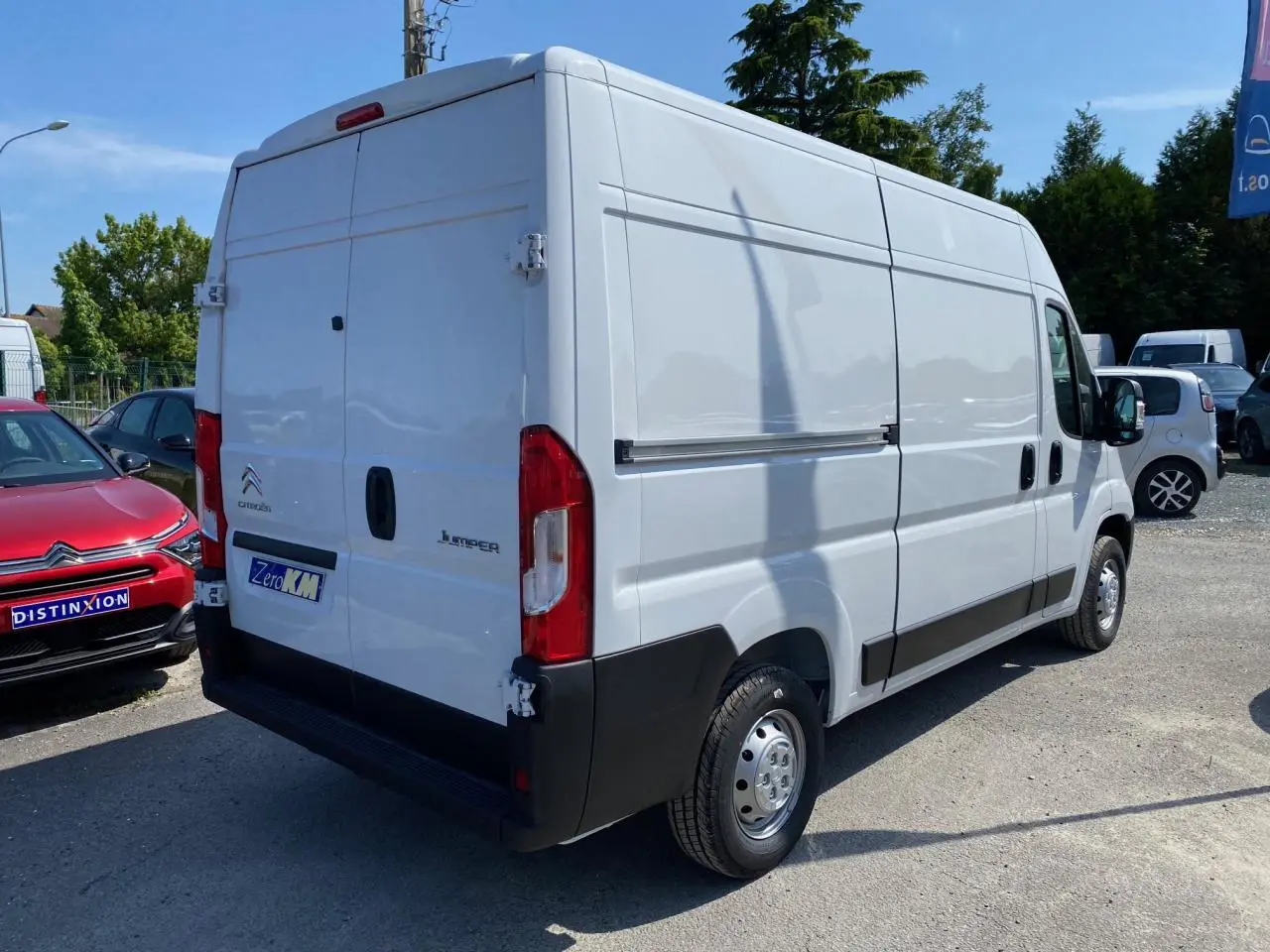 Vue 3/4 arrière droite d'un utilitaire Citroën Jumper blanc avec portes arrière tôlées et jantes acier.
