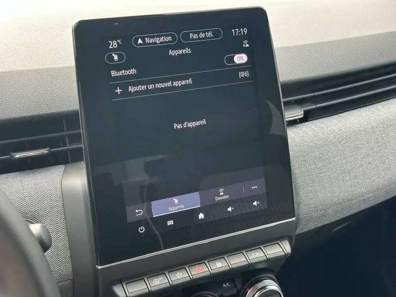 Écran tactile central de la Renault Clio 1.0 Eco-G 100ch Techno 2025 avec interface Bluetooth et tableau de bord gris.