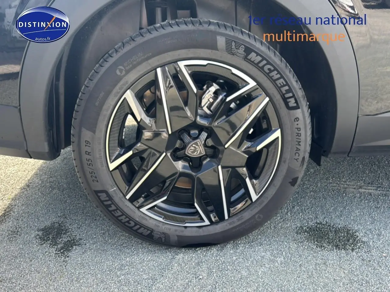 Gros plan sur la jante alu noire et argentée Michelin d’un Peugeot 5008 Hybrid 145 allure e-dcs6 noir, roue avant droite.