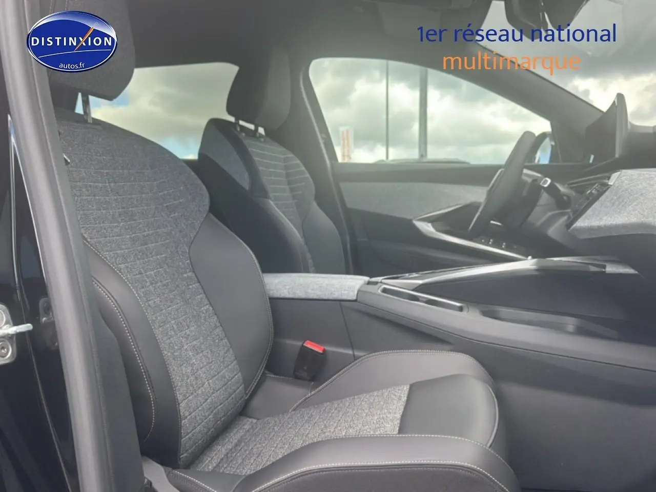 Intérieur de la Peugeot 5008 Hybrid 145 allure e-dcs6 2025, vue côté conducteur sur sièges tissu gris et cuir noir.
