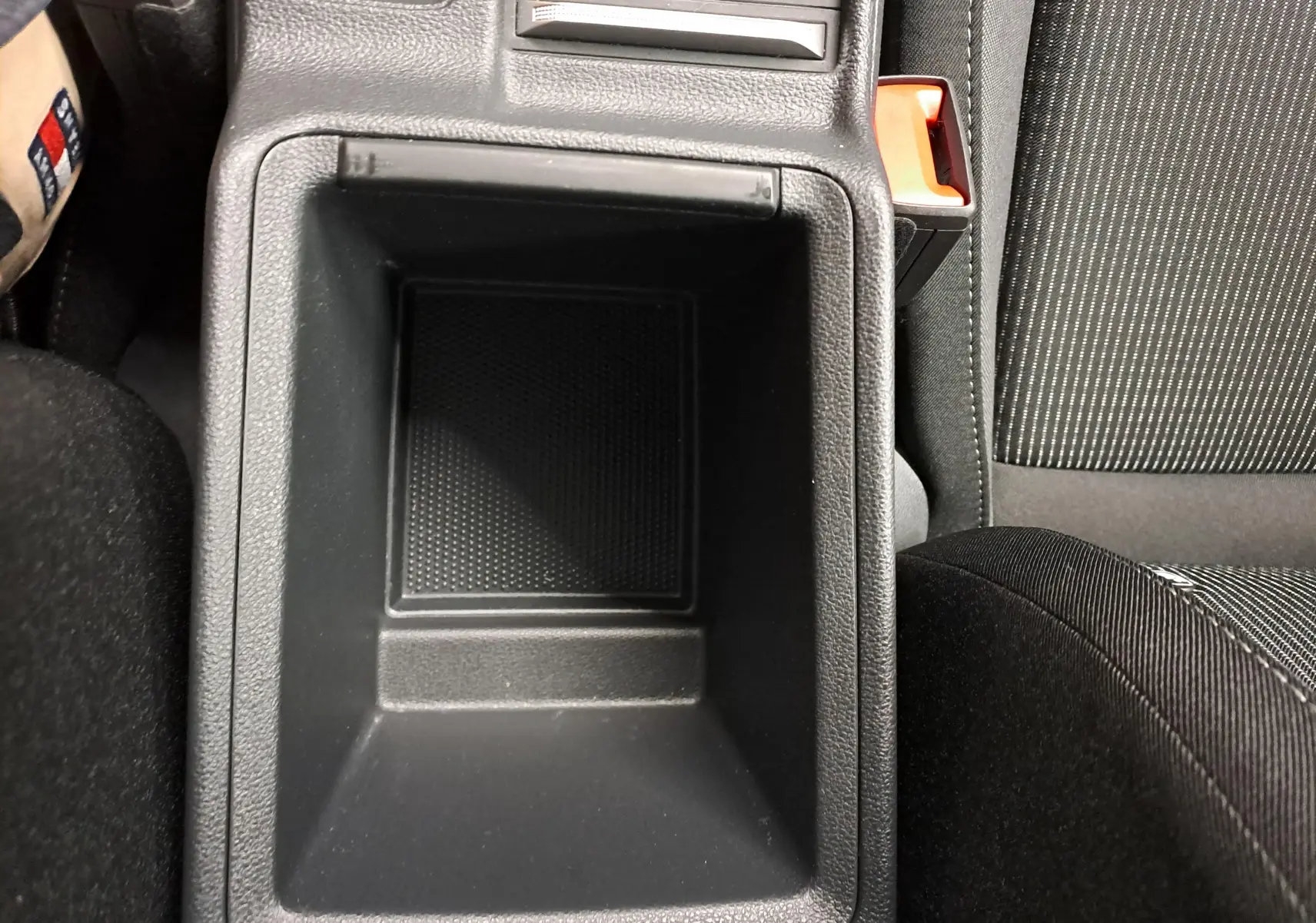 Vue plongeante sur le rangement central noir entre les sièges avant du Skoda Octavia Combi blanc Moon 2025.