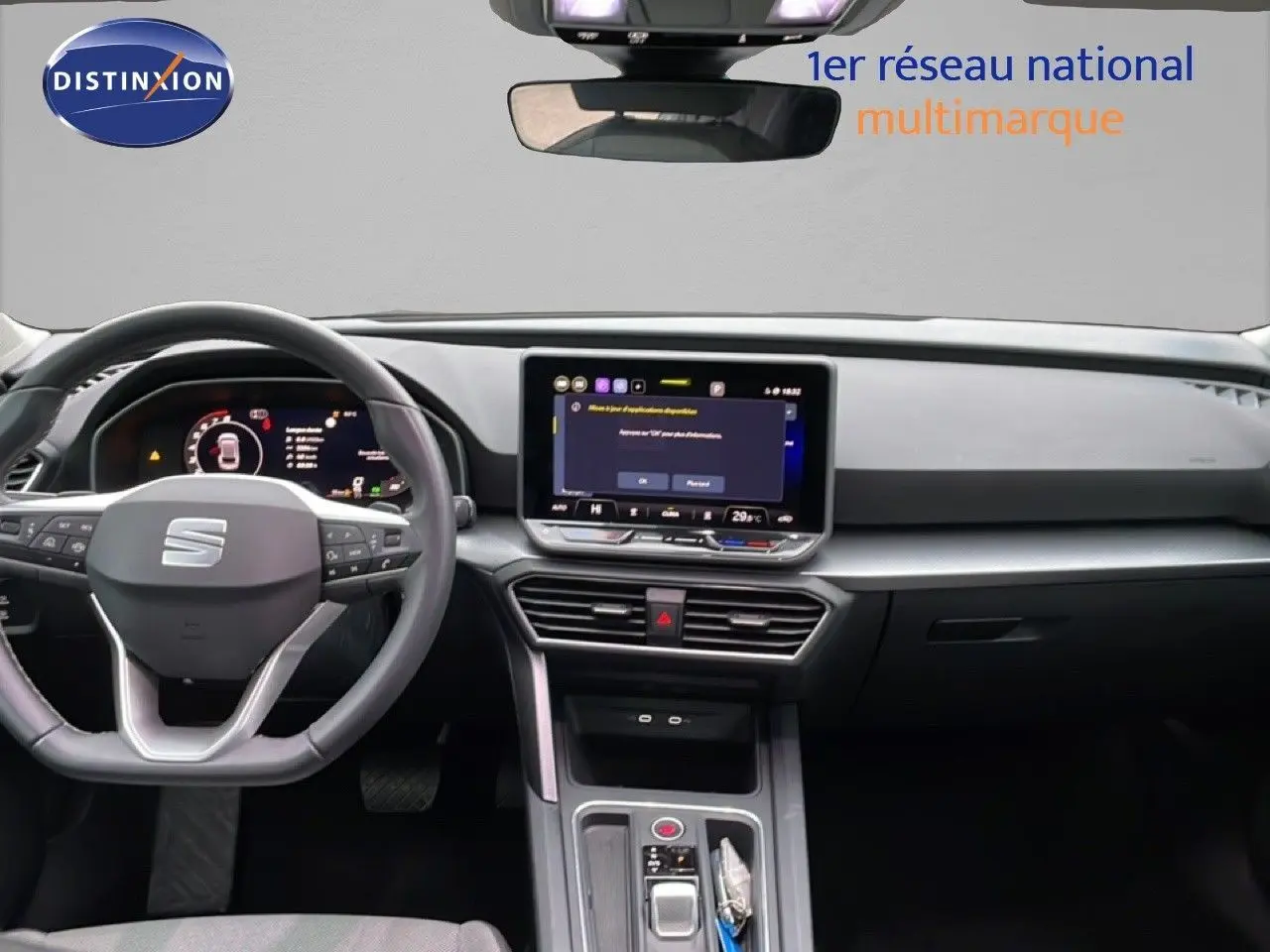 Intérieur de la SEAT Leon 2025 en vue frontale, tableau de bord moderne avec écran tactile central et volant multifonction.