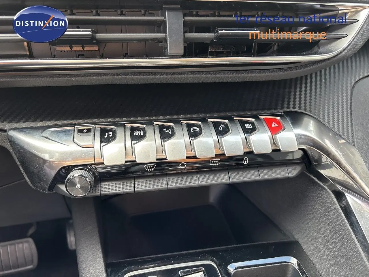 Détail de la console centrale du Peugeot 3008 HYBRID 180CH BVA8 Allure 2024, boutons argentés et finition noire.