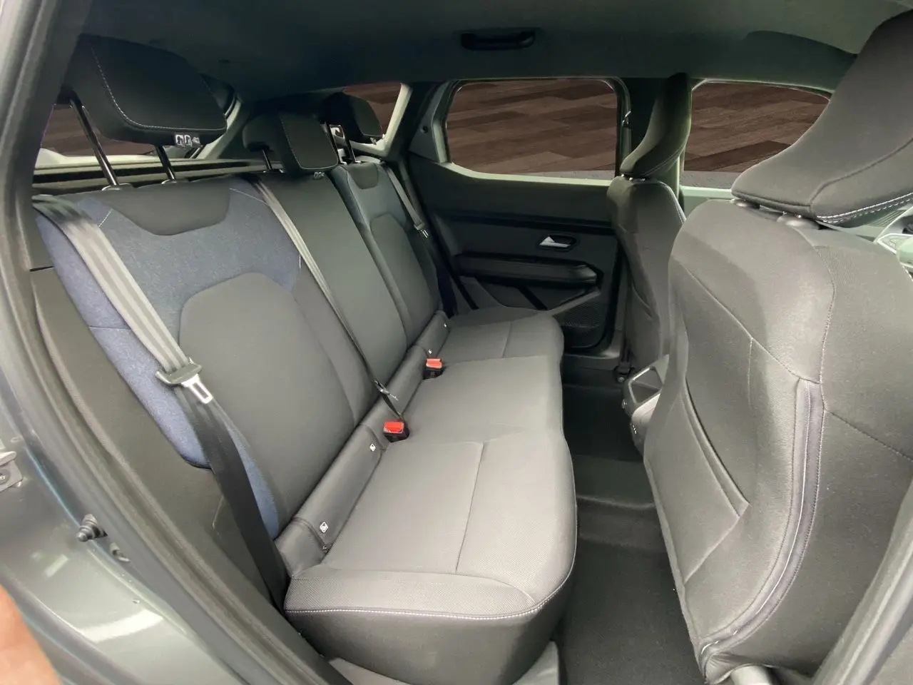 Banquette arrière en tissu noir et bleu vue côté gauche dans un Dacia Duster gris schiste 2025 hybride.