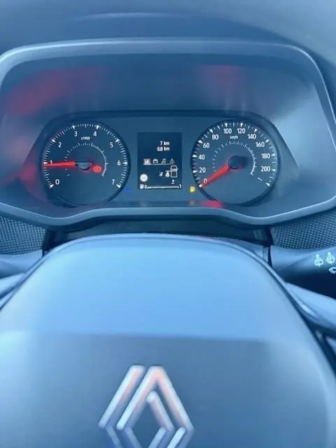 Vue rapprochée du tableau de bord du Renault Trafic Fourgon gris clair, avec compte-tours, compteur de vitesse et écran multifonctions.