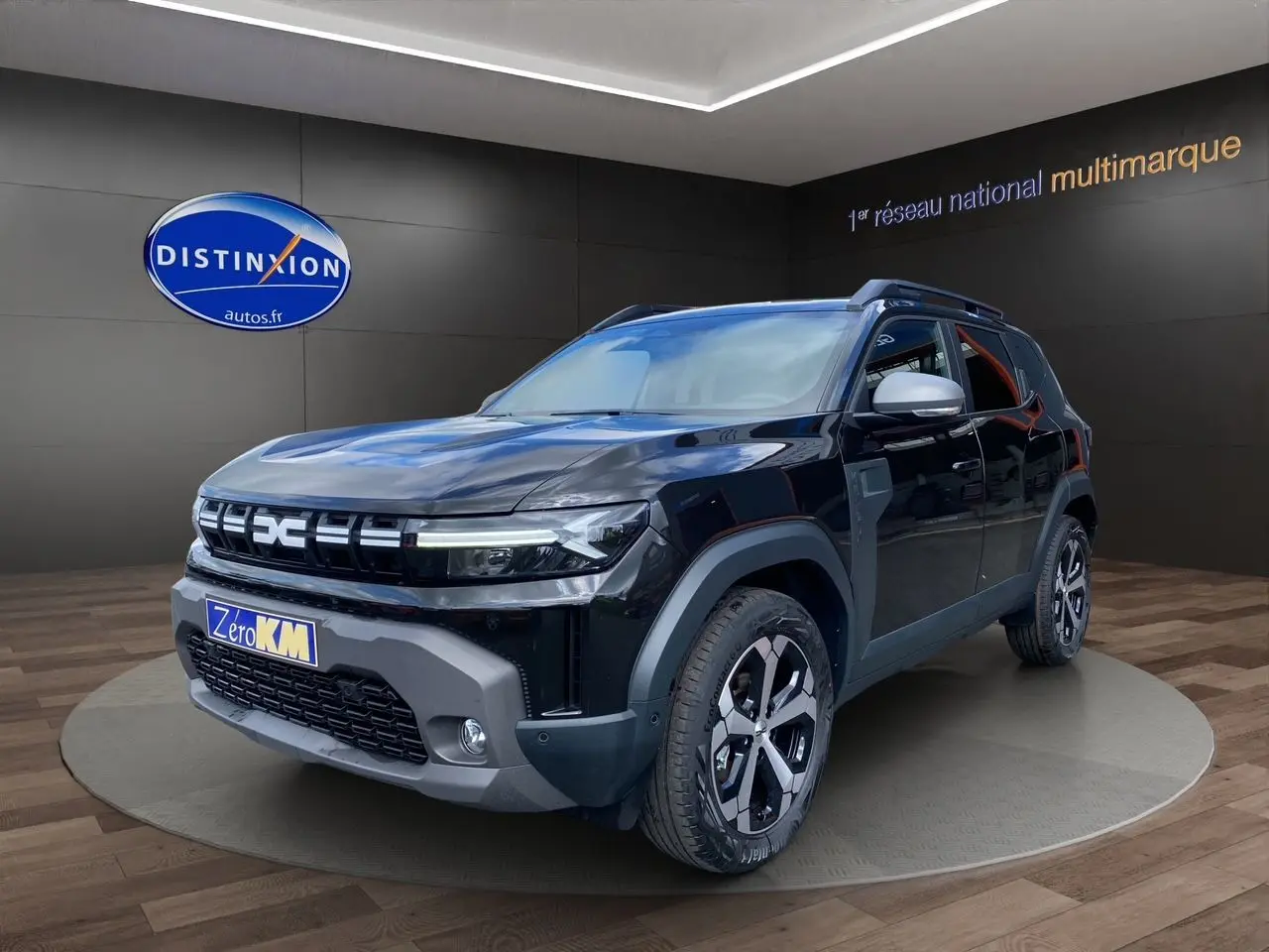 Vue 3/4 avant du Dacia Duster hybride noir avec jantes alliage et détails gris sur bouclier et rétroviseurs.