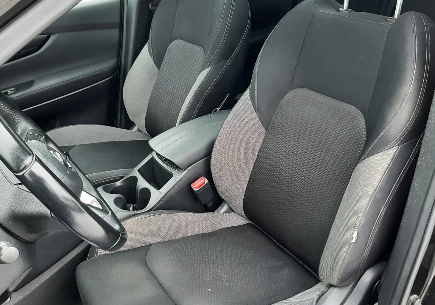 Vue intérieure rapprochée des sièges avant en tissu gris et noir du Nissan Qashqai DCI 115 N-Connecta 2020.
